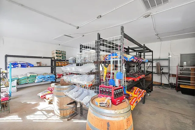 a room with lots of white furniture and a chandelier