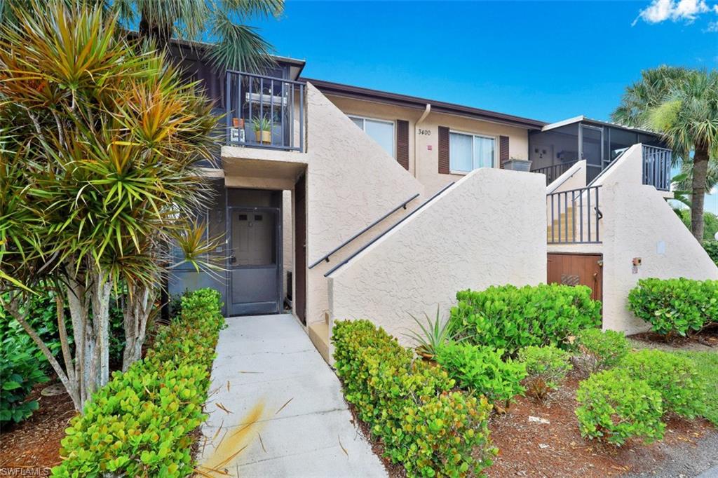 3400 Frosty Way, Unit 4704 Naples, FL 34112 - Photo 1 of 20 a view of a house with a yard