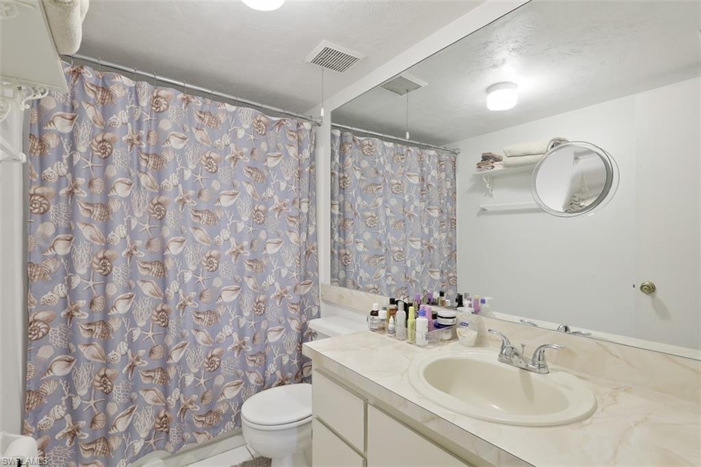 3400 Frosty Way, Unit 4704 Naples, FL 34112 - Photo 14 of 20 a bathroom with a sink toilet and shower