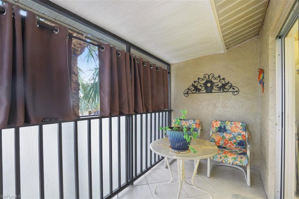3400 Frosty Way, Unit 4704 Naples, FL 34112 - Photo 16 of 20 a balcony with furniture and a potted plant