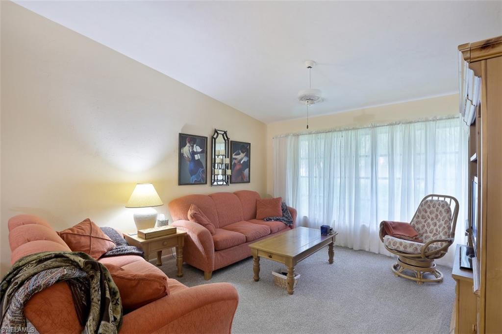 3400 Frosty Way, Unit 4704 Naples, FL 34112 - Photo 3 of 20 a living room with furniture and a chair