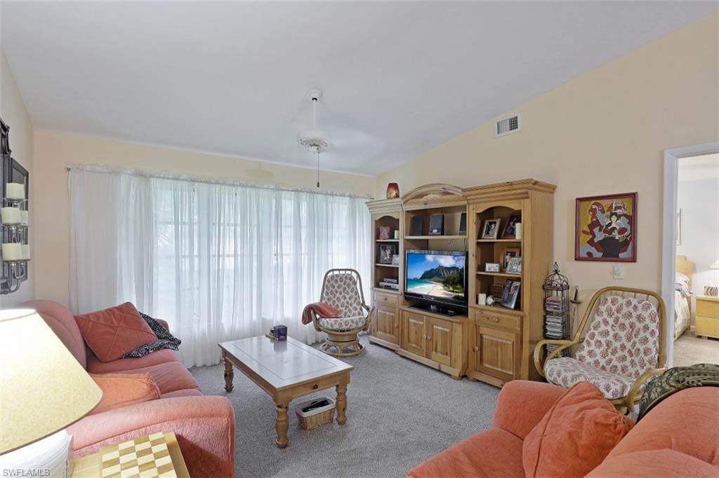 3400 Frosty Way, Unit 4704 Naples, FL 34112 - Photo 4 of 20 a living room with furniture and a flat screen tv