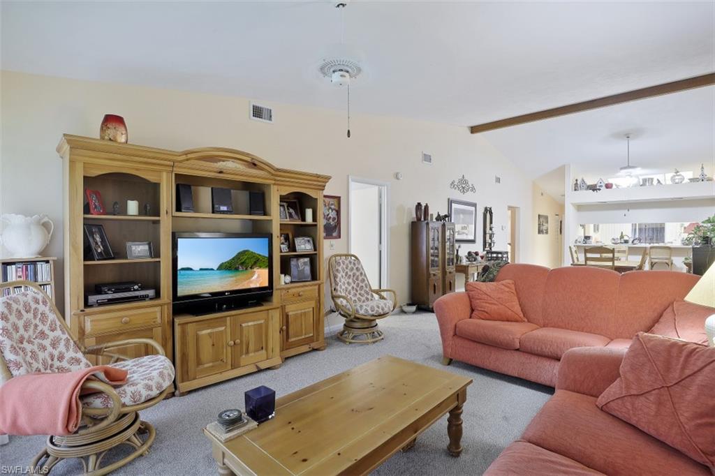 3400 Frosty Way, Unit 4704 Naples, FL 34112 - Photo 5 of 20 a living room with furniture and a flat screen tv