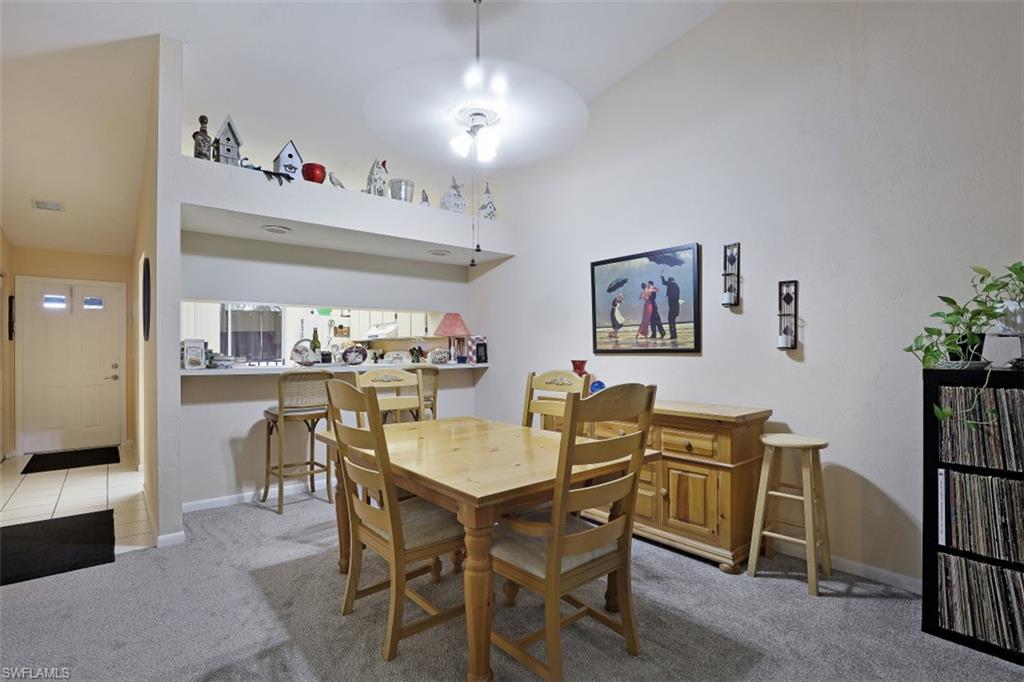 3400 Frosty Way, Unit 4704 Naples, FL 34112 - Photo 6 of 20 a view of a dining room with furniture and chandelier