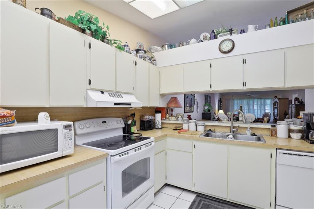 3400 Frosty Way, Unit 4704 Naples, FL 34112 - Photo 7 of 20 a kitchen with cabinets appliances and a counter space