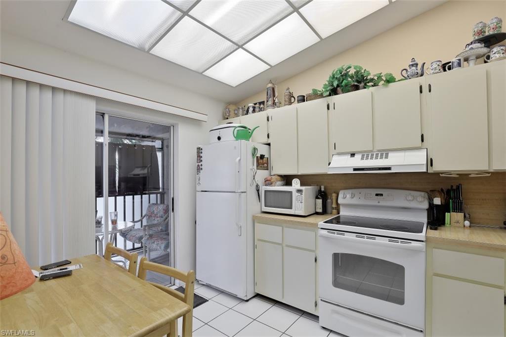3400 Frosty Way, Unit 4704 Naples, FL 34112 - Photo 8 of 20 a kitchen with a stove a refrigerator and a sink