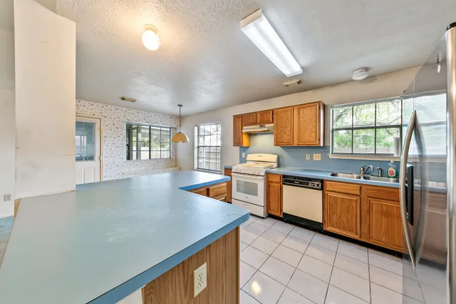a kitchen with a sink stove and cabinets