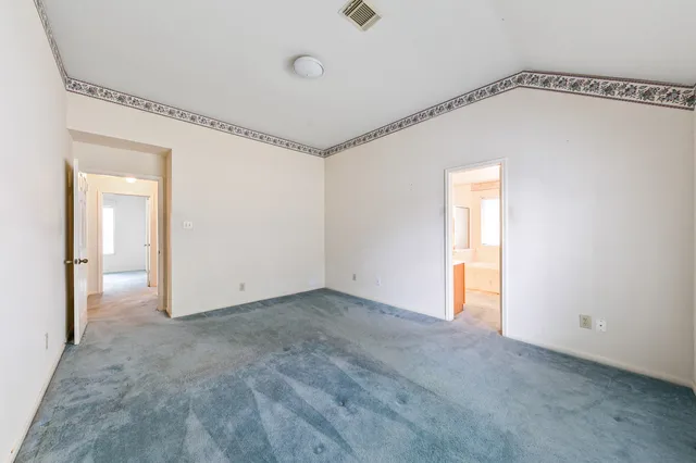 a kitchen with stainless steel appliances granite countertop a refrigerator a sink dishwasher a dining table and chairs with wooden floor