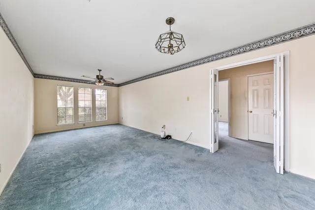 an empty room with windows and closet