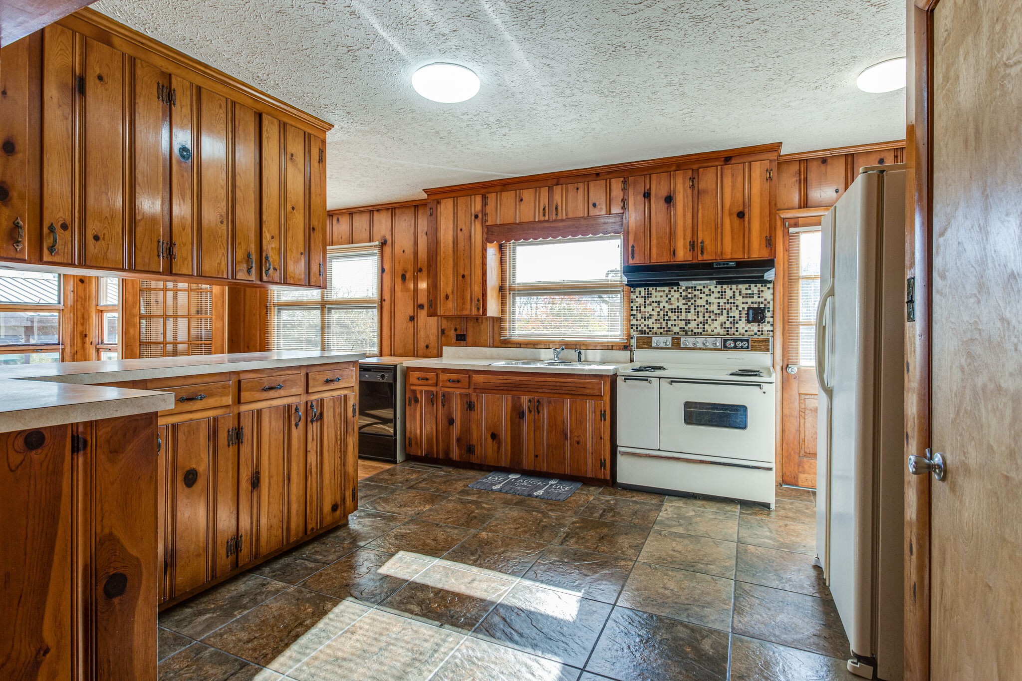 404 Monroe Floyd Road Decherd, TN 37324 - Photo 21 of 44 a kitchen with stainless steel appliances granite countertop a stove a sink and a refrigerator