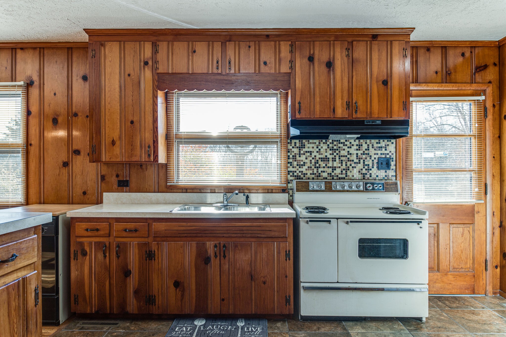 404 Monroe Floyd Road Decherd, TN 37324 - Photo 22 of 44 a kitchen with stainless steel appliances granite countertop wooden cabinets a stove and a sink