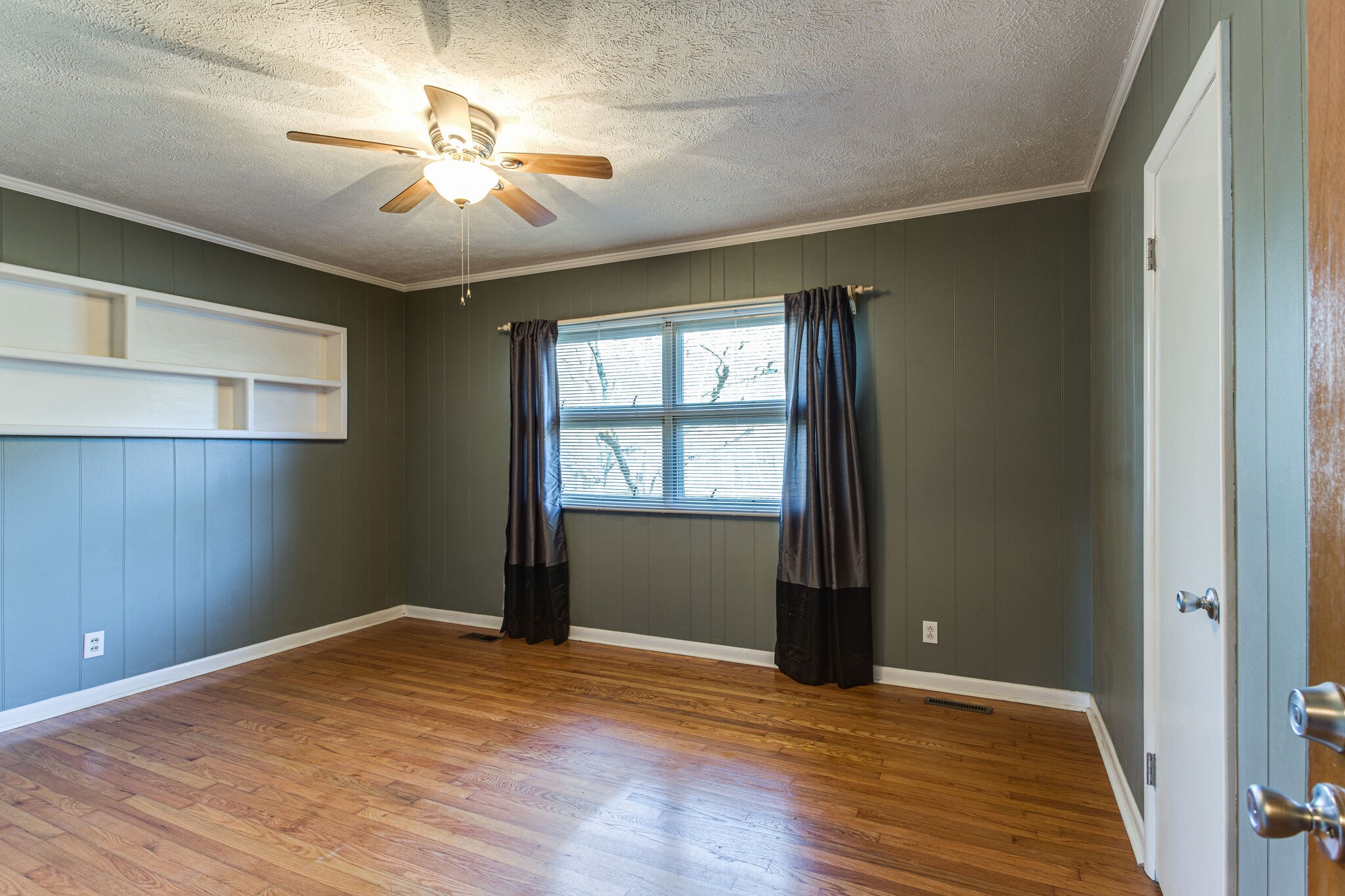 404 Monroe Floyd Road Decherd, TN 37324 - Photo 25 of 44 an empty room with wooden floor chandelier fan and windows