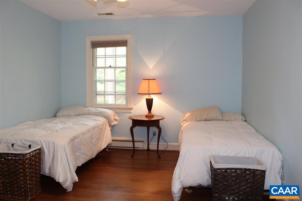 1724 Old Forge Road Charlottesville, VA 22901 - Photo 12 of 30 a bedroom with a bed a table and a window