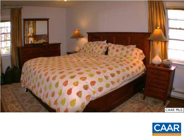 1724 Old Forge Road Charlottesville, VA 22901 - Photo 26 of 30 a bedroom with a bed and a lamp on dresser