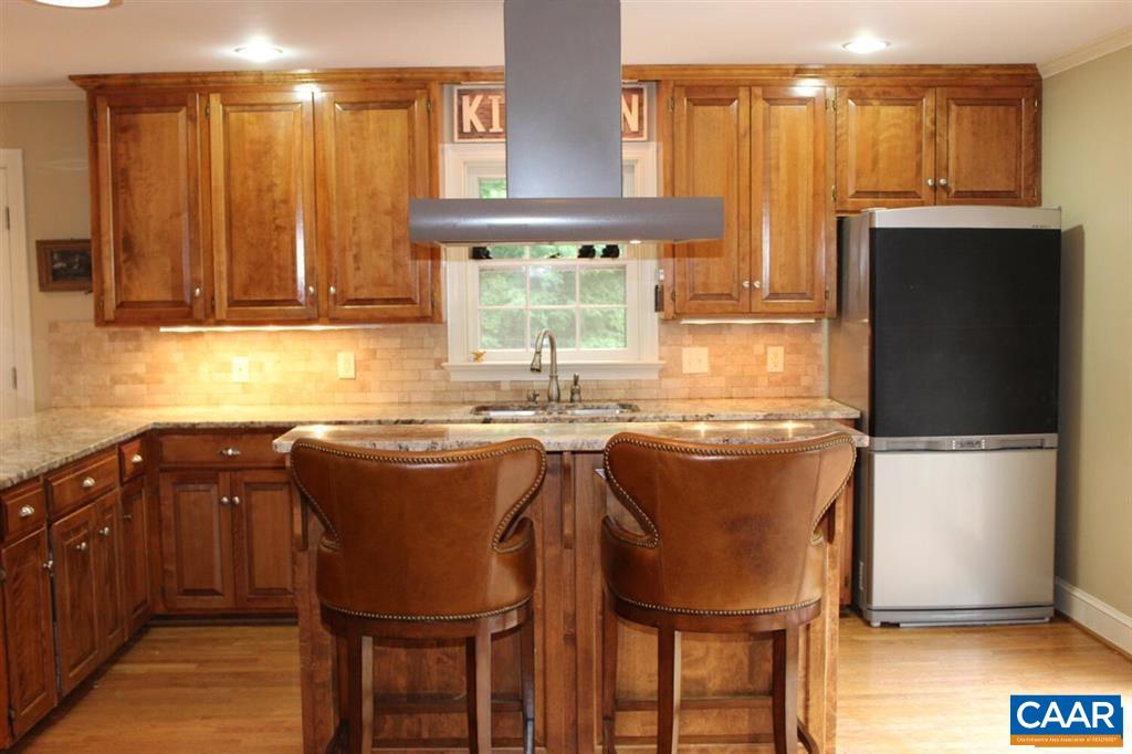 1724 Old Forge Road Charlottesville, VA 22901 - Photo 3 of 30 a kitchen with stainless steel appliances granite countertop a refrigerator a sink dishwasher a stove with wooden cabinets and floor