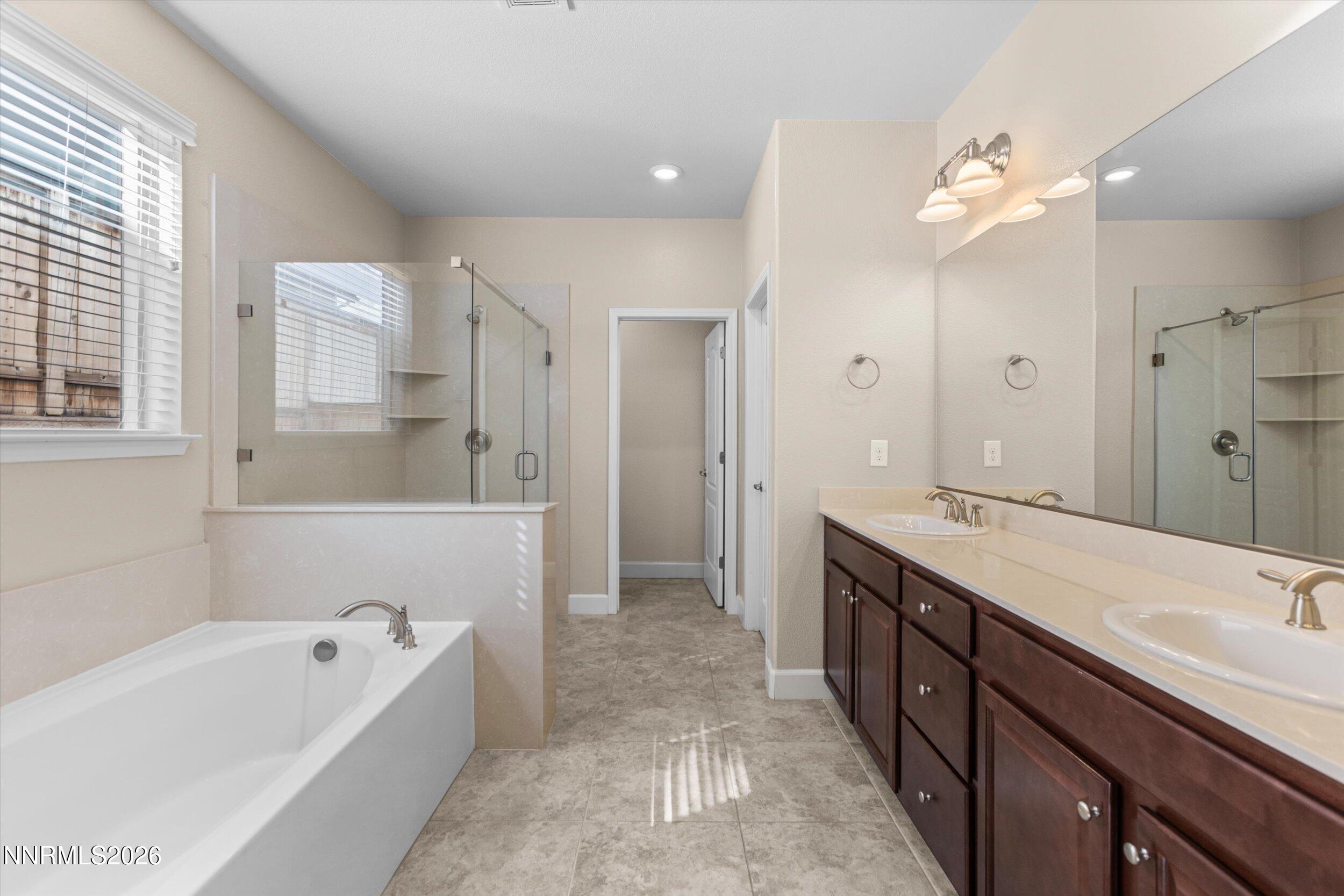 1725 Verdi Vista Court Reno, NV 89523 - Photo 17 of 37 a spacious bathroom with a tub sink shower and mirror