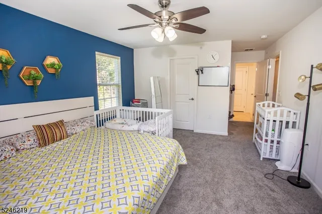 a bedroom with a bed and painting on the wall
