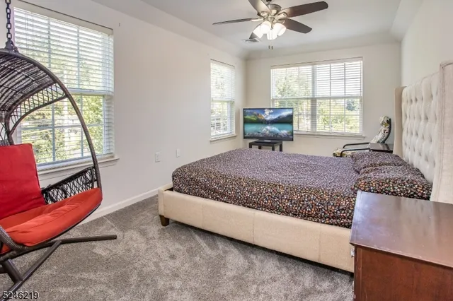 a living room with a bed furniture and a large window