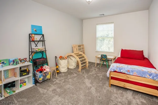 a bedroom with bed and a window