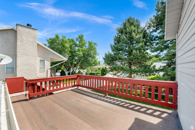 8029 Angel Street Sandy, UT 84070 - Photo 18 of 21 Outdoor deck featuring red painted railings and a textured surface