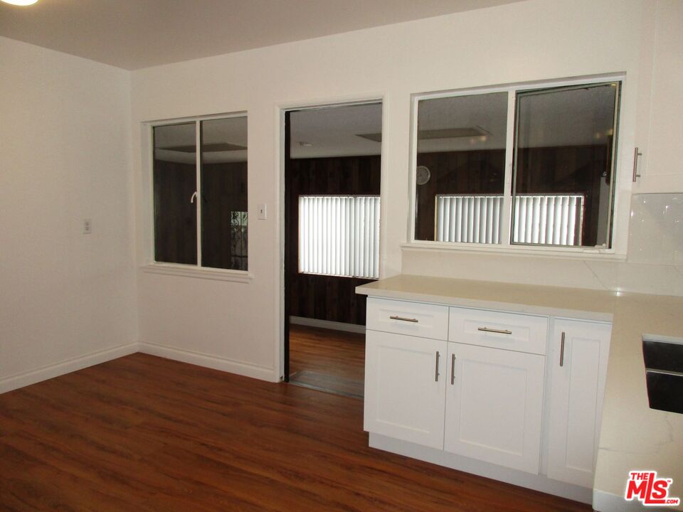 719 East 154th Street Compton, CA 90220 - Photo 14 of 32 a view of a kitchen with wooden floor and cabinet