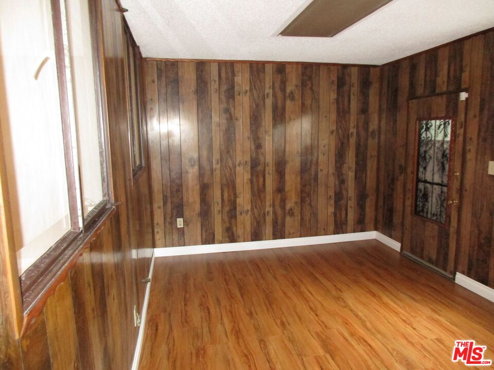 719 East 154th Street Compton, CA 90220 - Photo 15 of 32 a view of an empty room with wooden floor