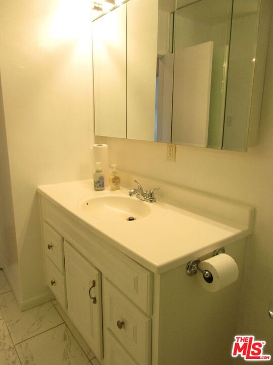 719 East 154th Street Compton, CA 90220 - Photo 21 of 32 a bathroom with a sink and a mirror