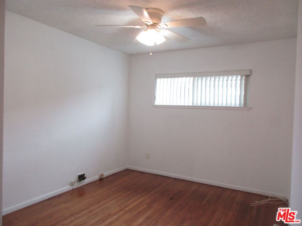 719 East 154th Street Compton, CA 90220 - Photo 22 of 32 an empty room with a window and a fan