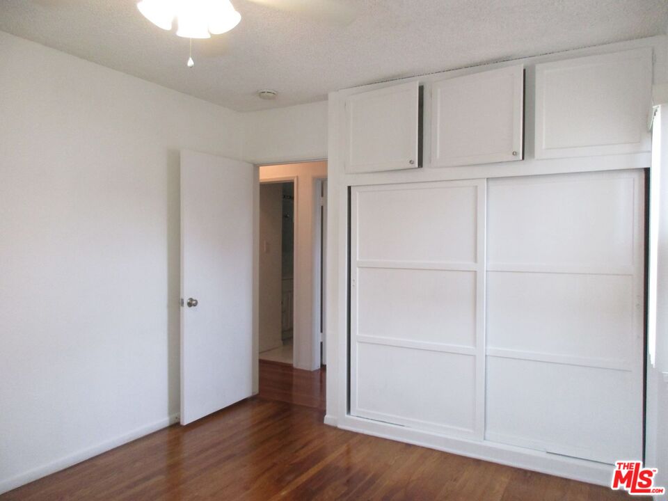 719 East 154th Street Compton, CA 90220 - Photo 23 of 32 an empty room with wooden floor