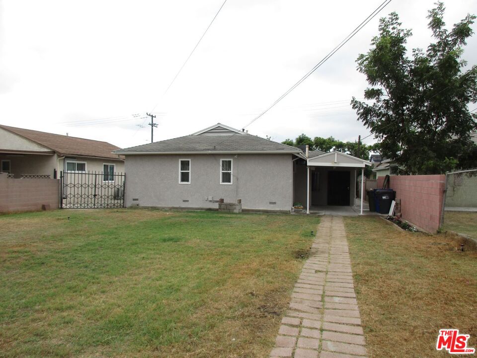 719 East 154th Street Compton, CA 90220 - Photo 26 of 32 a front view of a house with garden
