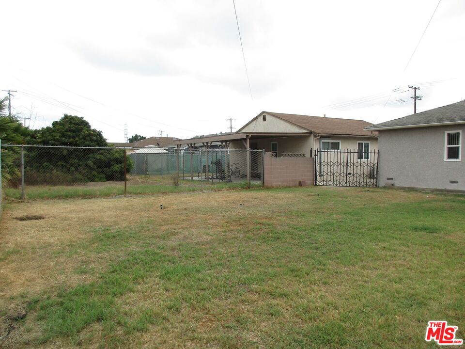 719 East 154th Street Compton, CA 90220 - Photo 30 of 32 a front view of a house with a yard