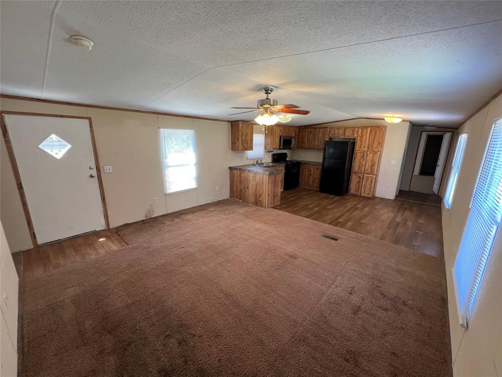 1647 Stonecrest Road Argyle, TX 76226 - Photo 11 of 16 an empty room with fireplace and windows