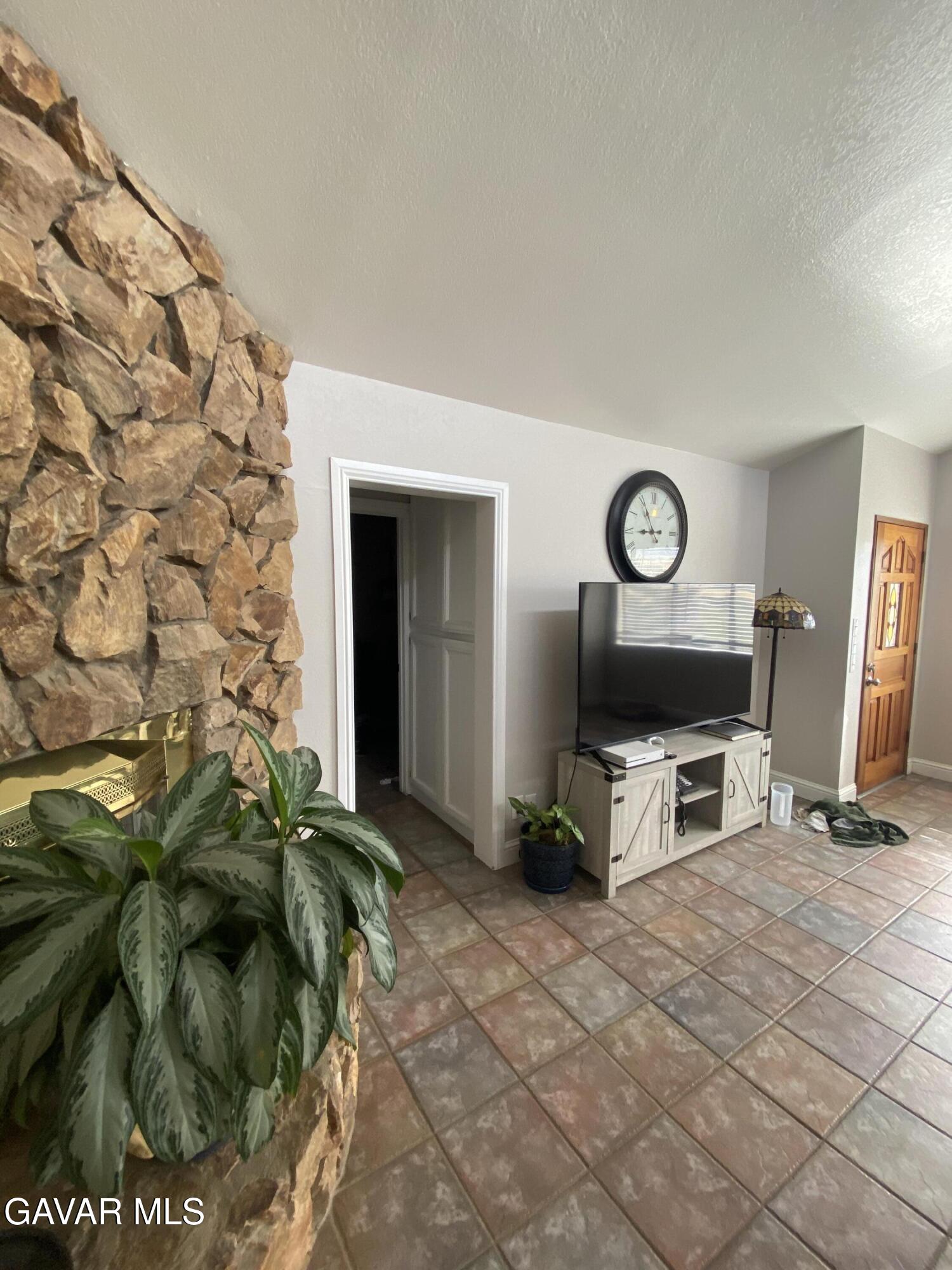 20909 Ridgeway Drive Tehachapi, CA 93561 - Photo 7 of 13 a living room with fireplace furniture and a flat screen tv