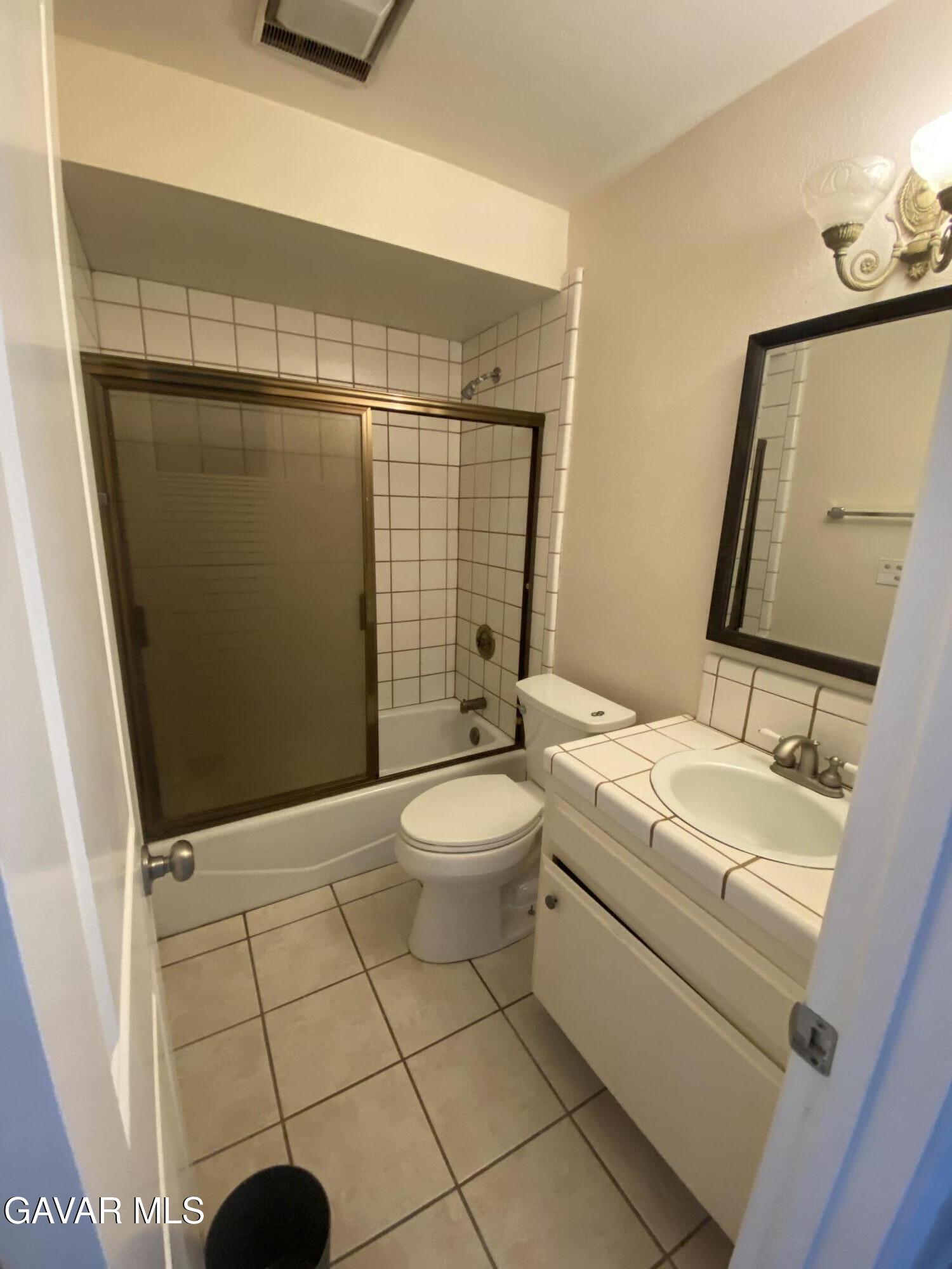 20909 Ridgeway Drive Tehachapi, CA 93561 - Photo 8 of 13 a bathroom with a toilet a sink and mirror