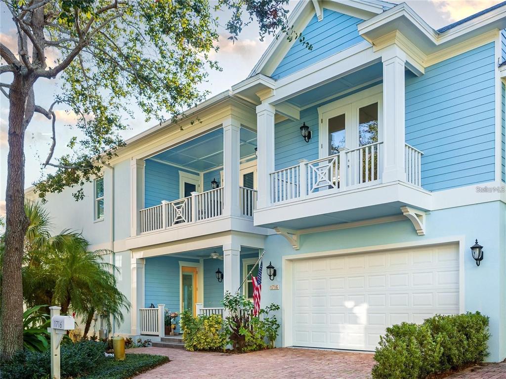 a front view of a house with a yard garage and outdoor seating