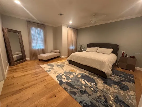 a bedroom with a large bed and a window