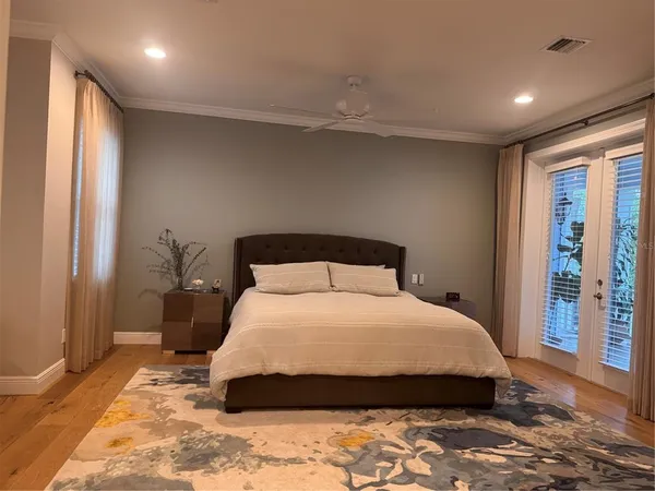 a bedroom with a large bed and a large window