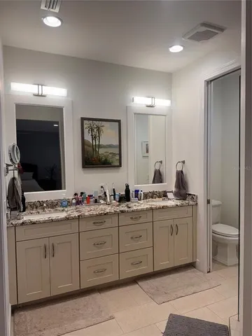 a bathroom with a double vanity sink and a mirror