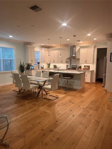 a living room with stainless steel appliances kitchen island granite countertop a sink and cabinets