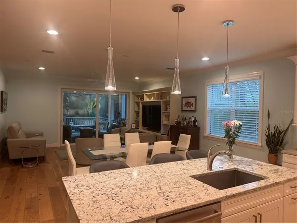a kitchen with sink and view of living room