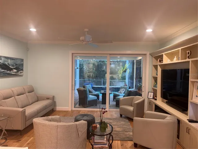 a living room with furniture and a floor to ceiling window