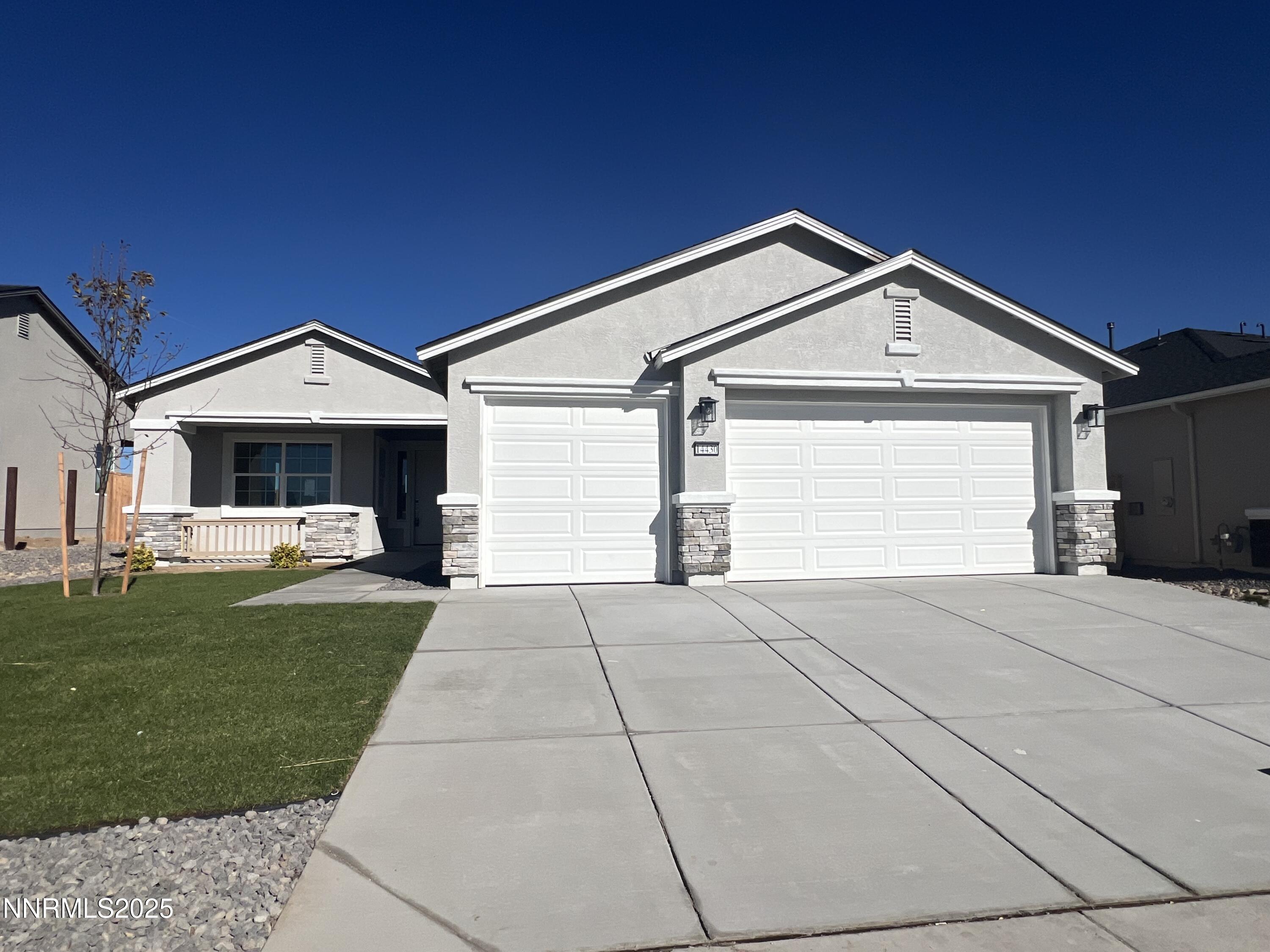 14430 Fredonia Drive Reno, NV 89506 - Photo 2 of 9 a front view of a house with a yard and garage