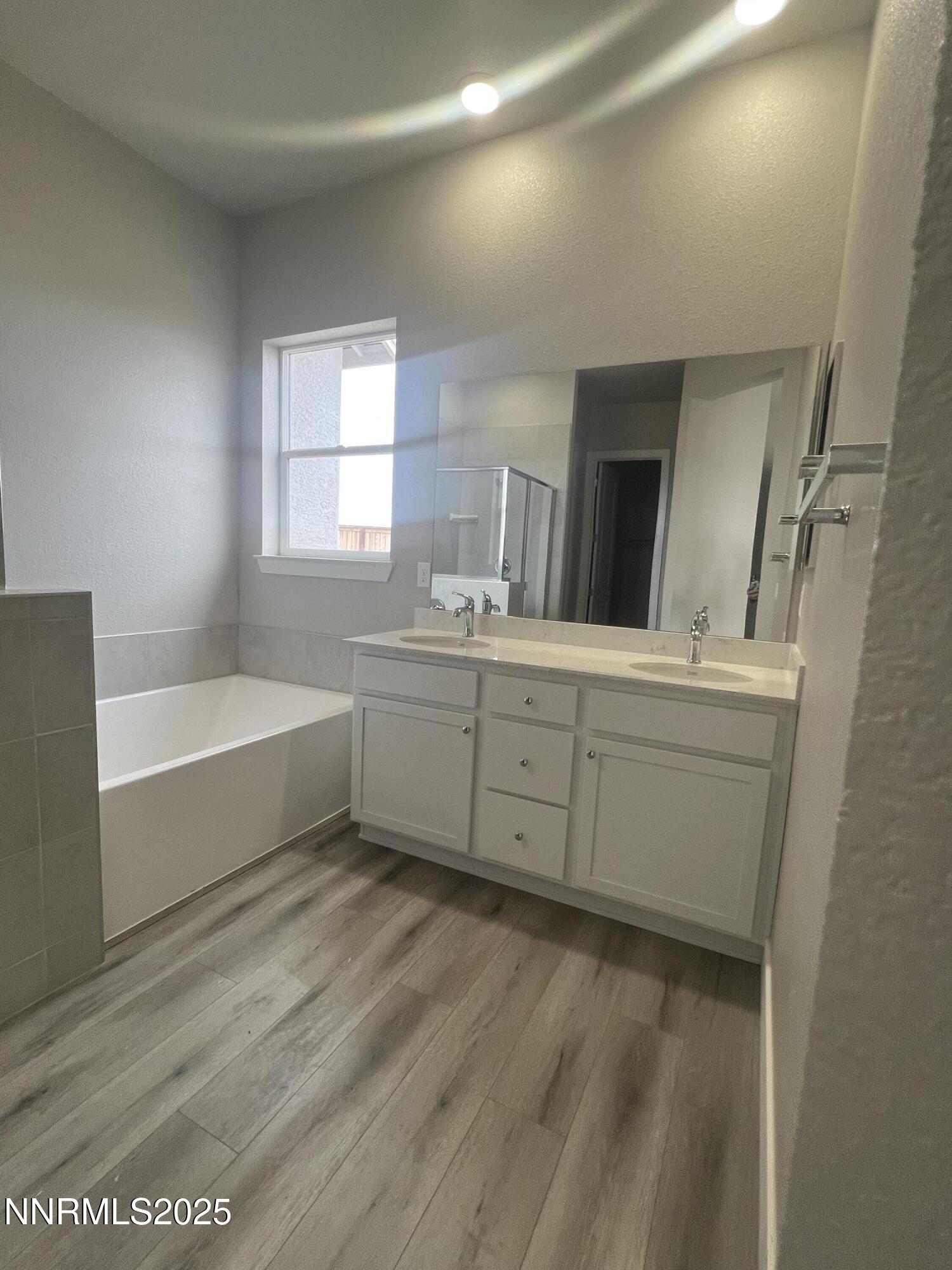 14430 Fredonia Drive Reno, NV 89506 - Photo 4 of 9 a bathroom with a bathtub sink and mirror