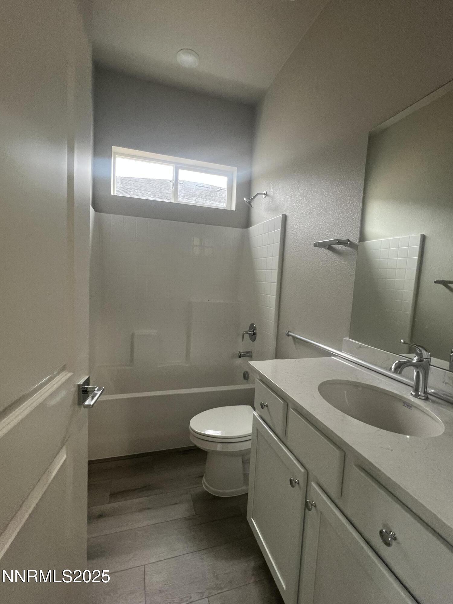 14430 Fredonia Drive Reno, NV 89506 - Photo 8 of 9 a bathroom with a sink a toilet and shower