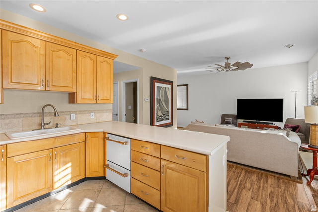 7824 South Sequoia Tree Lane Sandy, UT 84094 - Photo 43 of 43 Kitchen featuring a peninsula, light countertops, open floor plan, a ceiling fan, and dishwasher
