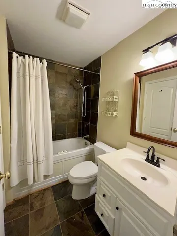 a bathroom with a sink toilet a mirror and shower