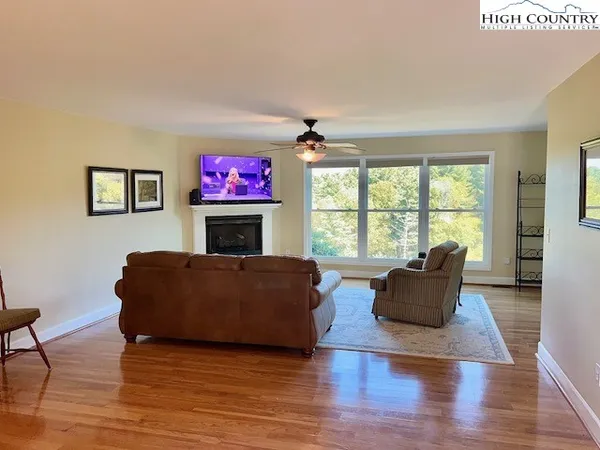 a living room with furniture fireplace and window