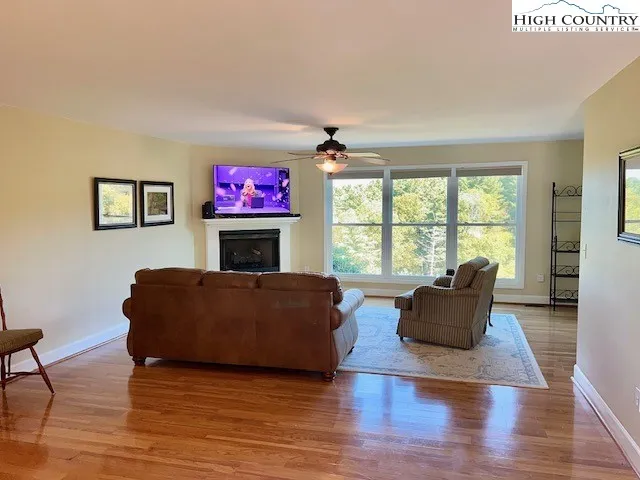 a living room with furniture fireplace and window