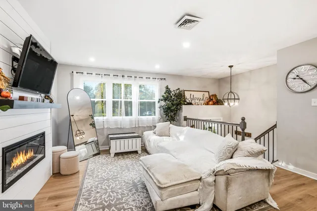 a kitchen with stainless steel appliances granite countertop a dining table chairs refrigerator sink and cabinets