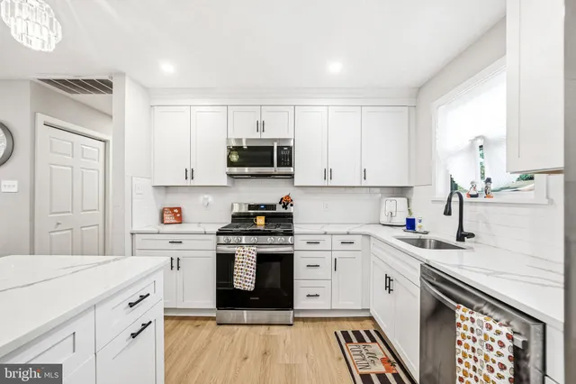 a bedroom with a bed and a wooden floor